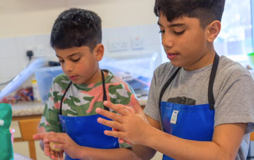 Boys cooking on cookery course